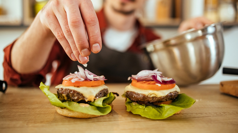 Close up of chef assembling a burger