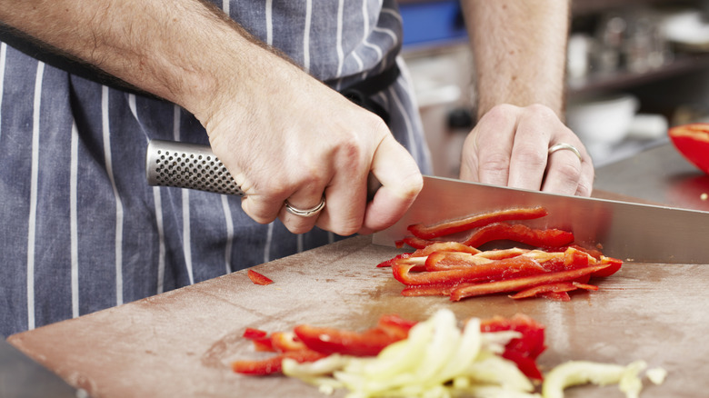 Close up of chef chopping vegetables