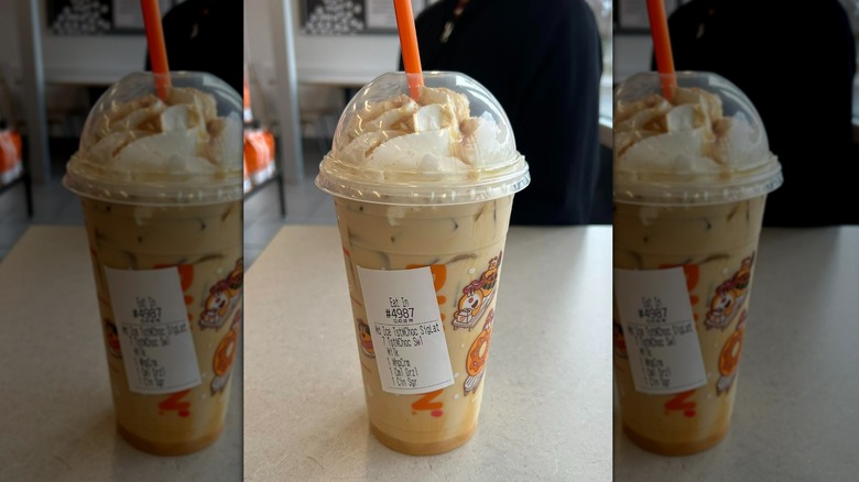 Dunkin's Toasted White Chocolate Swirl drink in plastic lidded cup with straw