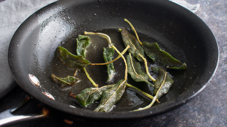 Fried sage in a pan on the stovetop