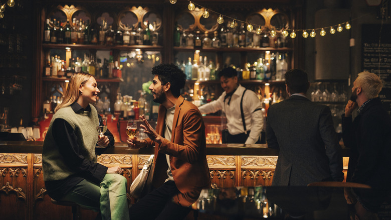 People sitting at a fancy looking bar having drinks