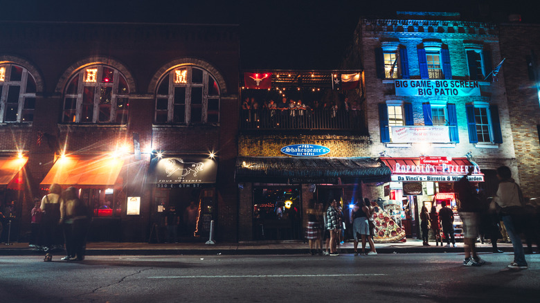 A street view of various bars at night