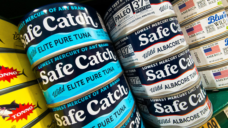 Several cans of Safe Catch on display at a store