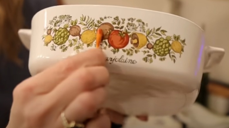 Woman using a lead test swab on Corningware dish decorations