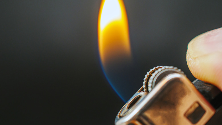 A lighter with a blue and orange flame