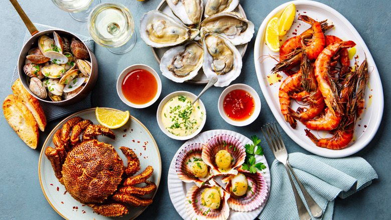 Small array of seafood dishes with small bowls of sauces.