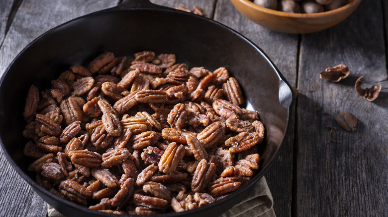 Candied pecans in a cast iron skillet