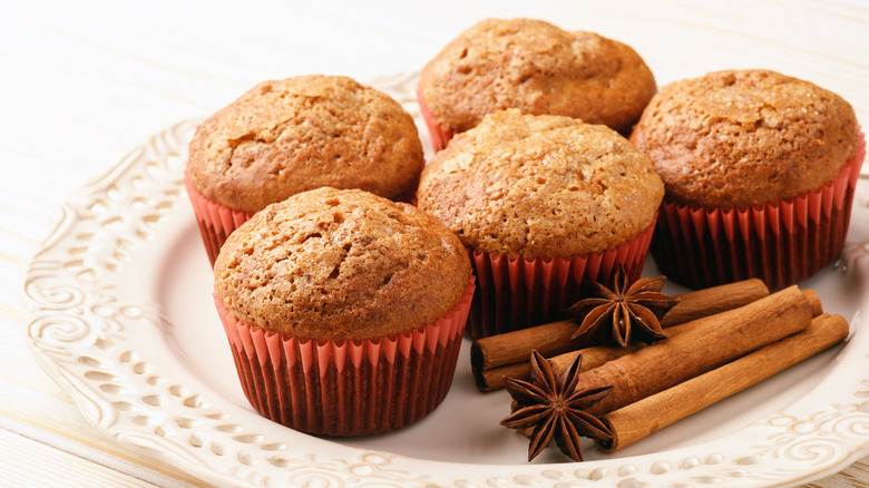 Muffins on plate with cinnamon sticks and star anise pods