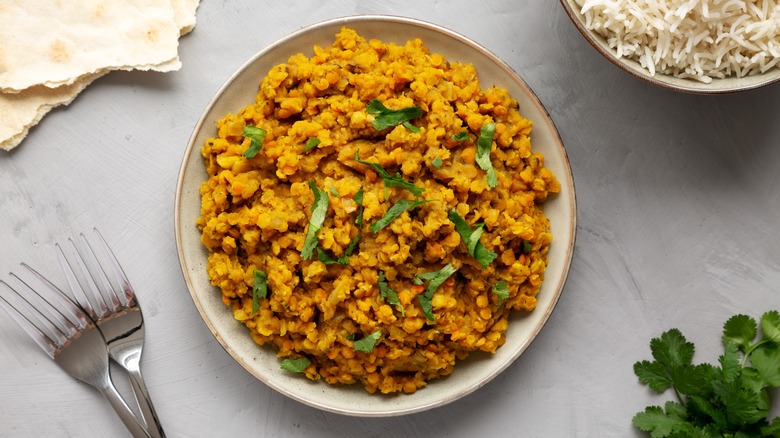 Plate of red lentil dahl, garnished with fresh cilantro