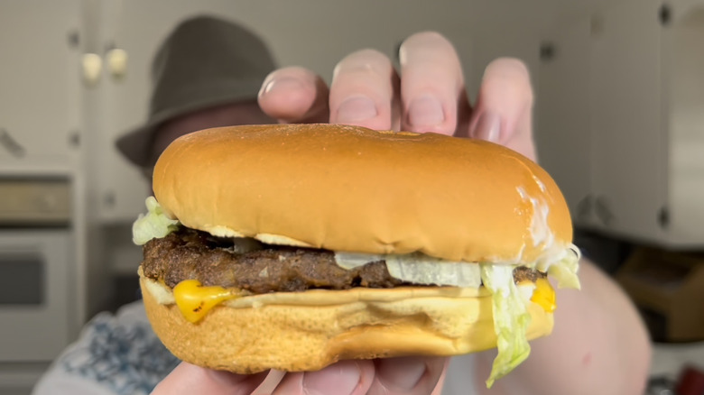 Person holding Hickory BBQ Cheeseburger