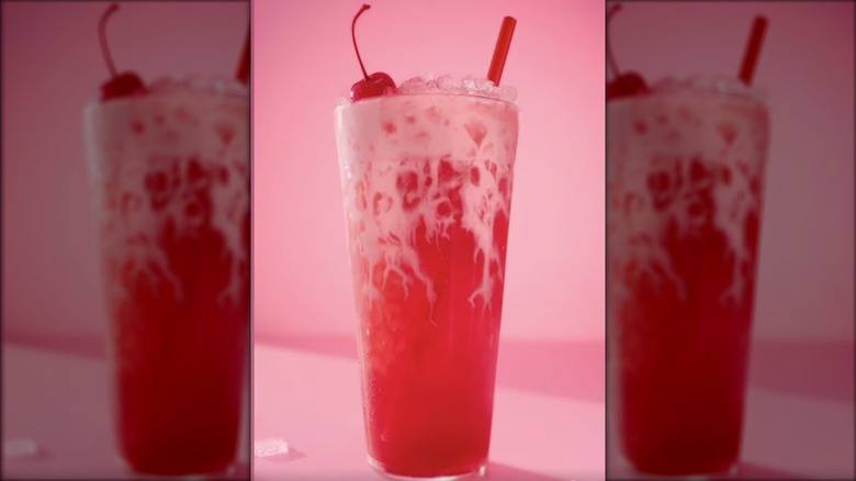 Sonic Pink Lady drink in a clear glass with cherry on top