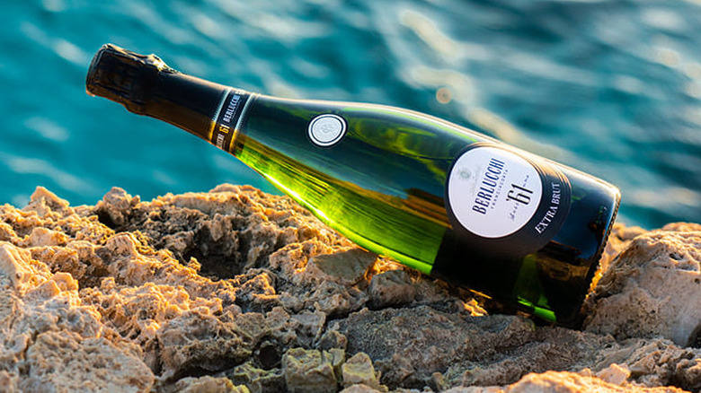 bottle of sparkling wine with water background