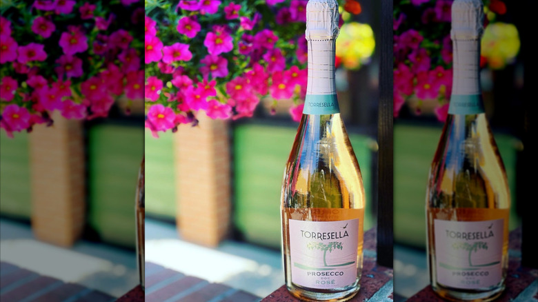 bottle of rose prosecco with flowers