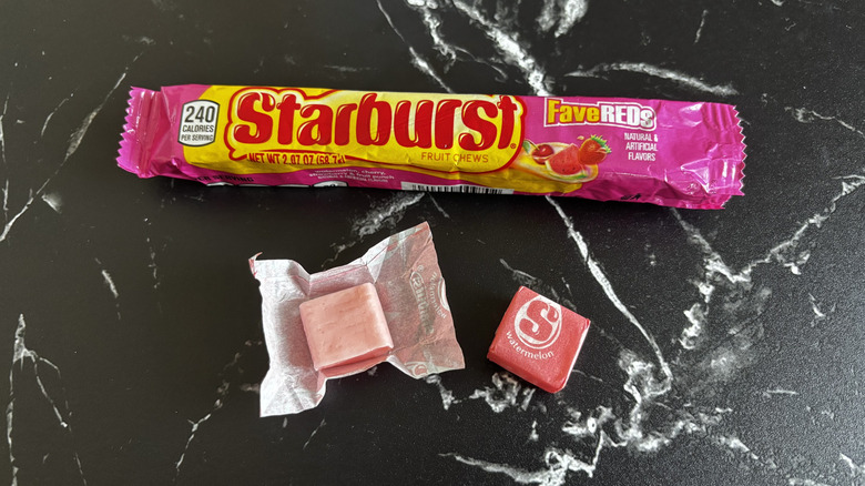 Starburst candy package next to wrapped and unwrapped watermelon Starburst