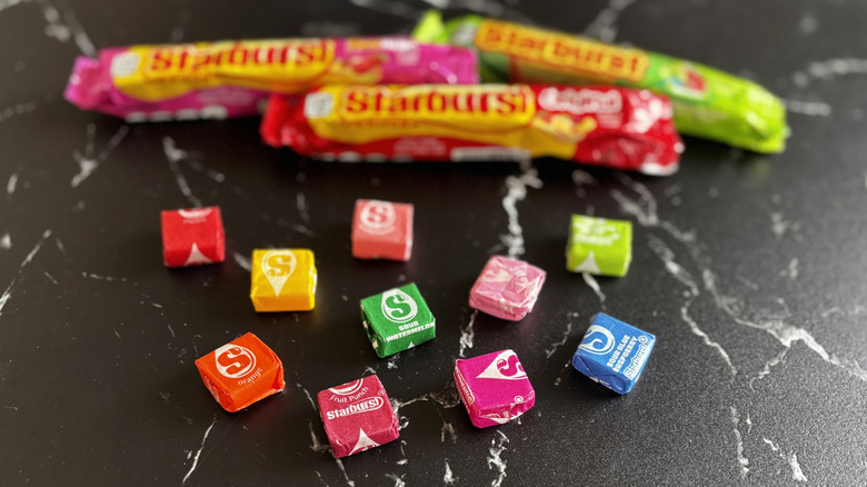 Various Starburst candies and packaging on countertop