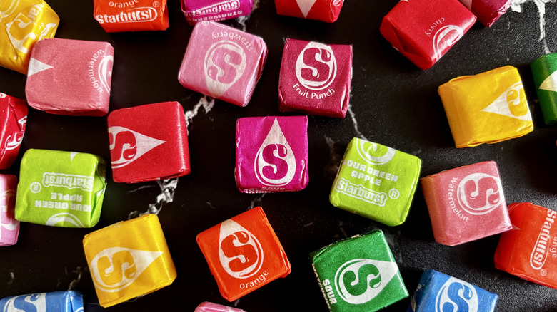 Various Starburst candies on table
