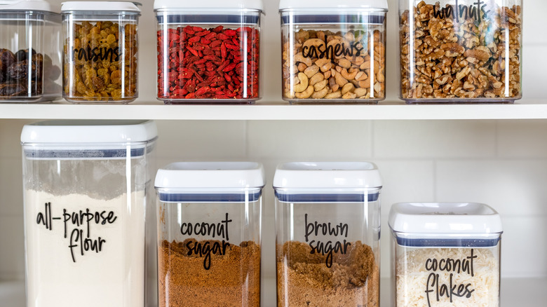 Neatly organized and labeled jars placed on a pantry shelf