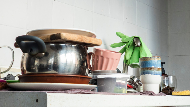 Dirty dishes stacked on a kitchen countertop