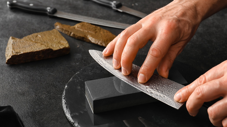 Hand polishing a knife on a whetstone