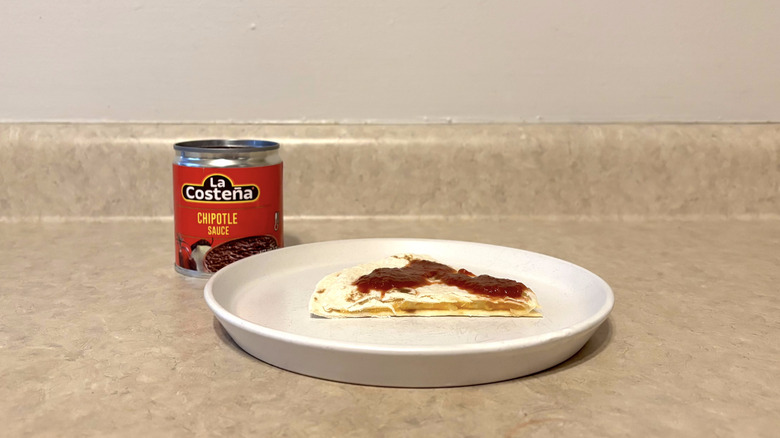 La Costena chipotle sauce on white plate on countertop