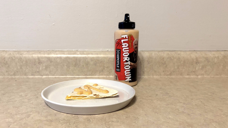 Guy Fieri's Flavortown kickin' chipotle sauce on quesadilla on white plate on countertop