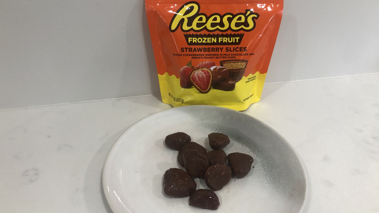 Reese's Frozen Strawberry Slices with Milk Chocolate & Reese's Peanut Butter Chips on a plate.