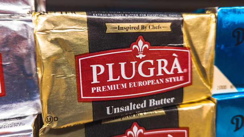 Package of Plugra premium butter on grocery store shelf