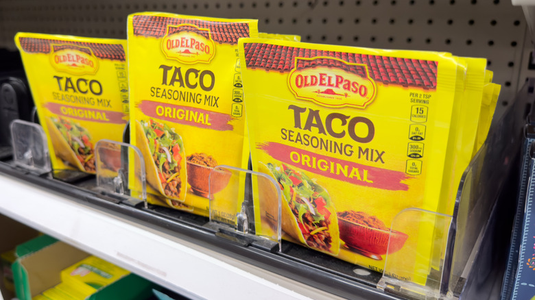 Packets of taco seasoning mix on grocery store shelf