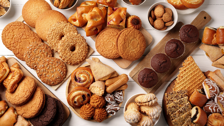 A variety of cookies placed together with baked goods on a white background
