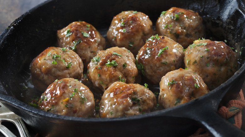 Freshly cooked meatballs placed in a skillet