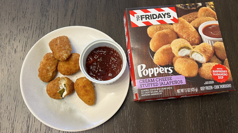 TGI Fridays Cream Cheese Stuffed Jalapeño Poppers in a box and on a white plate with a dish of raspberry habañero dipping sauce