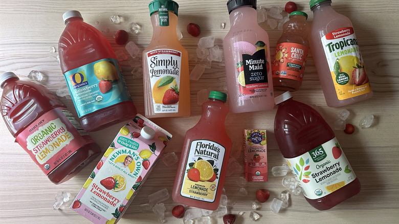 Bottles of strawberry lemonade on wooden table