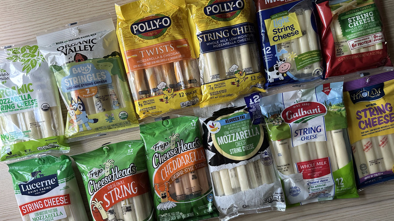 Packages of string cheese on wooden table