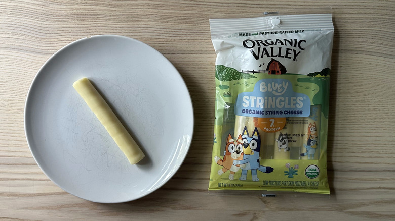 Organic Valley string cheese on wooden table