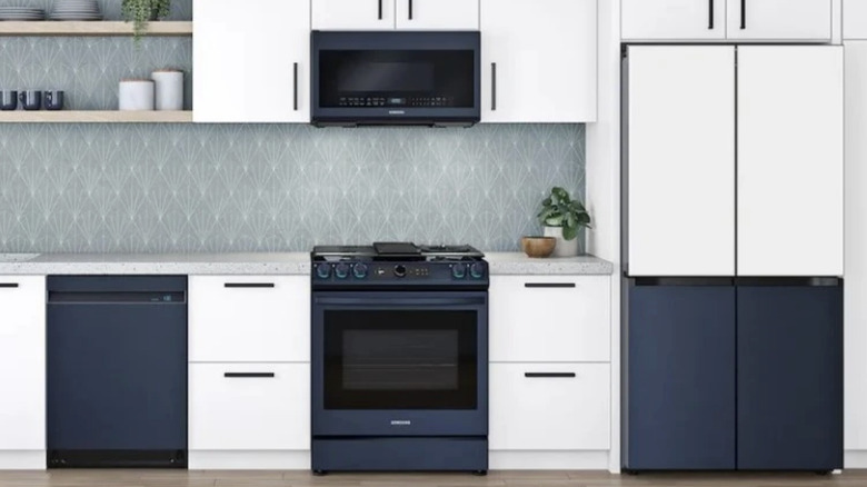A white kitchen with navy blue appliances