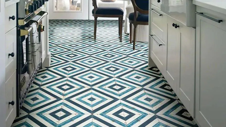 A square blue, teal, and white patterned tile kitchen floor
