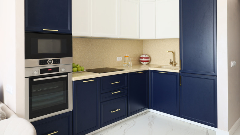 Elegant modern kitchen design featuring beautiful navy blue cabinets