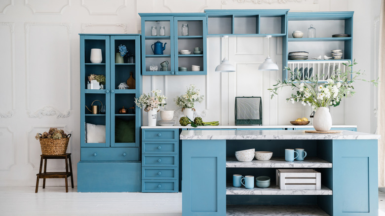 White kitchen with all blue cabinets and an island