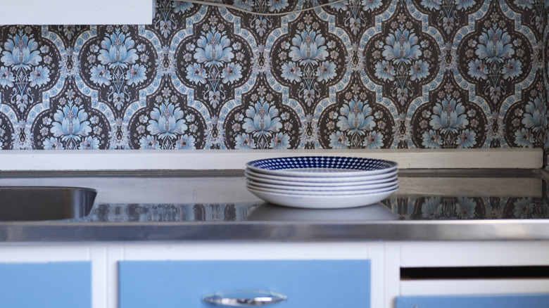 Blue patterned wallpaper on a kitchen backsplash