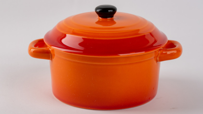 Orange Dutch oven against a white background