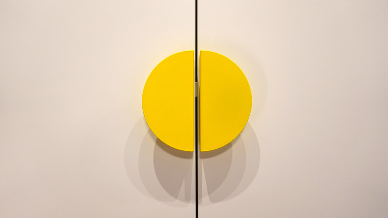 Yellow handles on closed cabinet doors