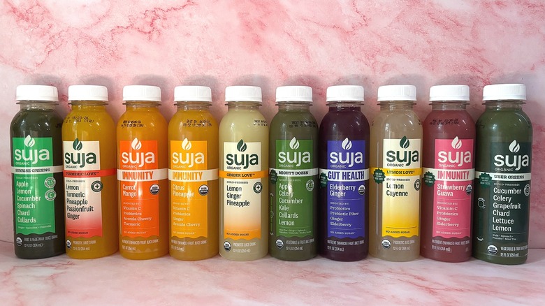 10 Suja Juices lined up on table