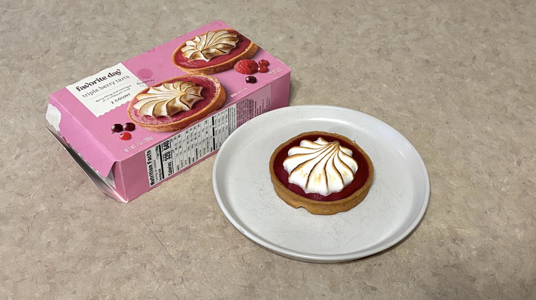 Favorite Day triple berry tarts on white plate and box on neutral background