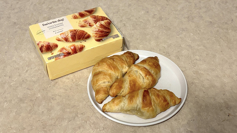 Favorite Day mini butter croissants on white plate and box on neutral background