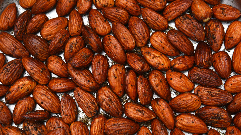 Close-up of roasted almonds with coffee grounds