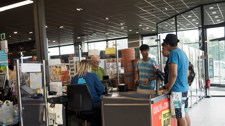 Customers paying for groceries at an ALDI checkout