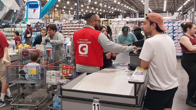 Customers in a Costco store check out line