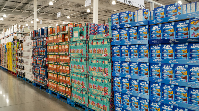 stacked snack and protein bar boxes in Costco warehouse aisle