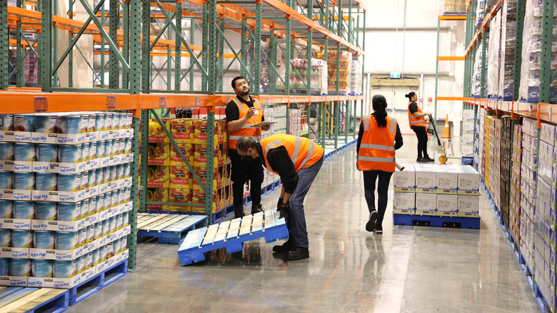 People stock the shelves at the new Costco Warehouse