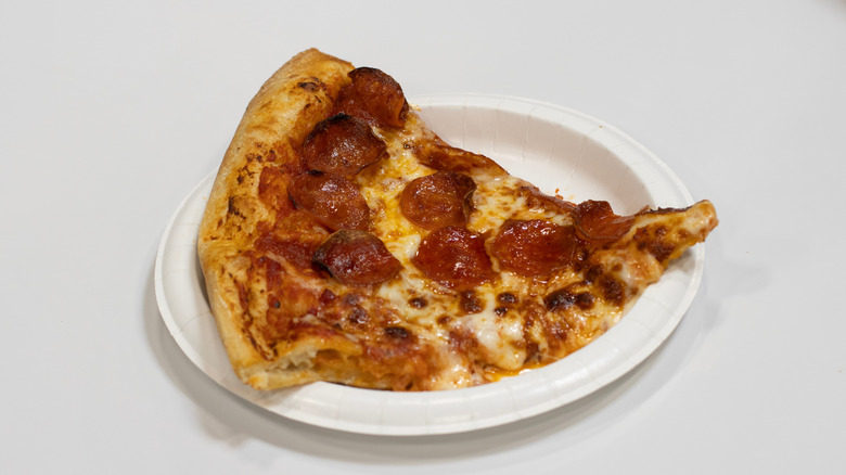 A slice of pepperoni pizza on the table at a Costco food court
